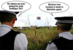 Police observe the Camp For Climate Action at Heathrow